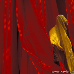 A Woman Worker At A Fabric Drying Hanger In A Fabric Dyeing Factory