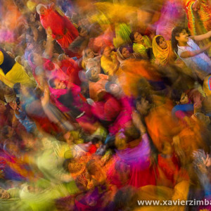 Spring in India, Cheerful Women Praying And Singing Holy Verses In A Temple Among Crowds Of Pilgrims Celebrating Holi, Festival Of Colours And Love